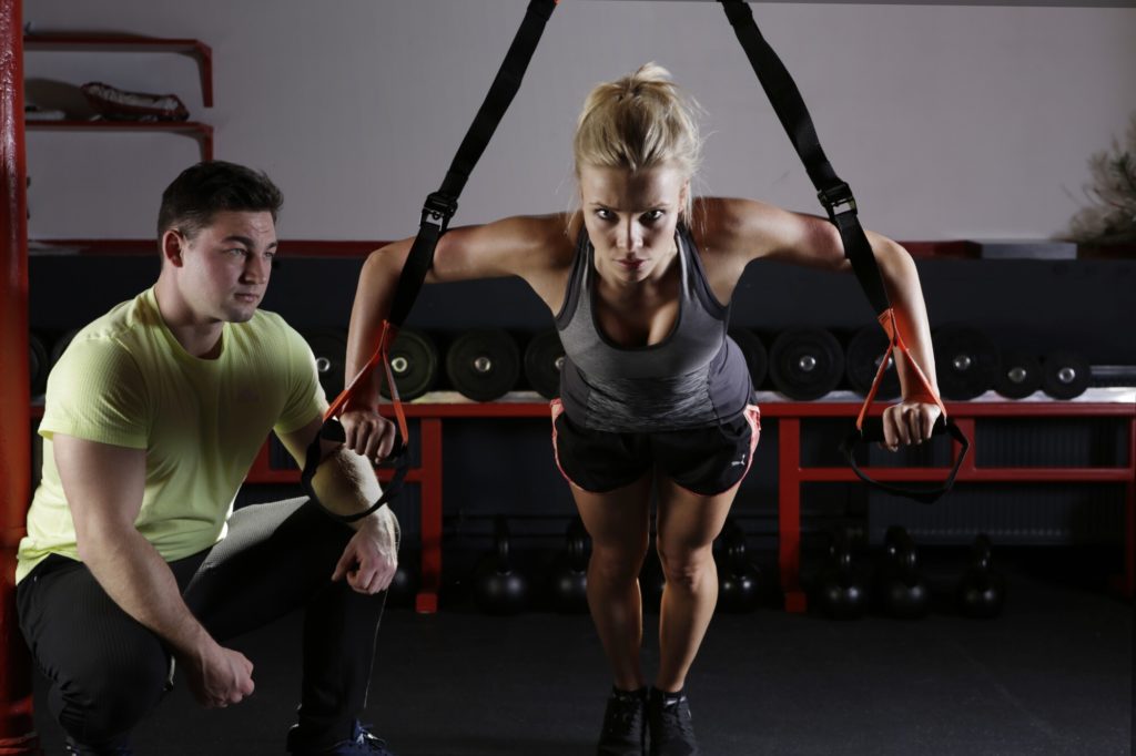 female gym instructor leading a personal training session